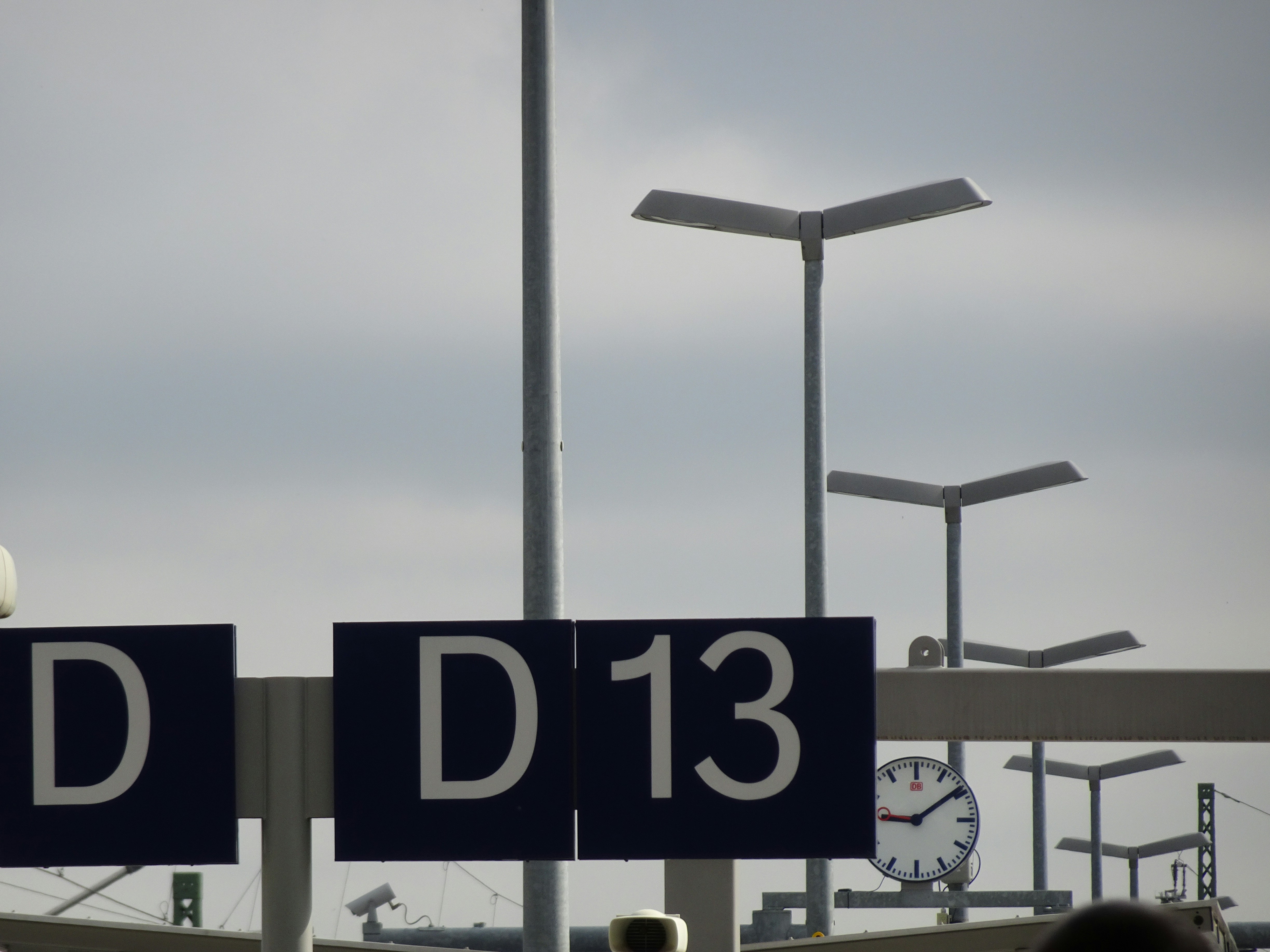 White and black departure information sign inside an airport terminal