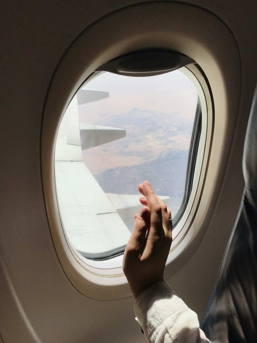 person in car looking at the window of airplane