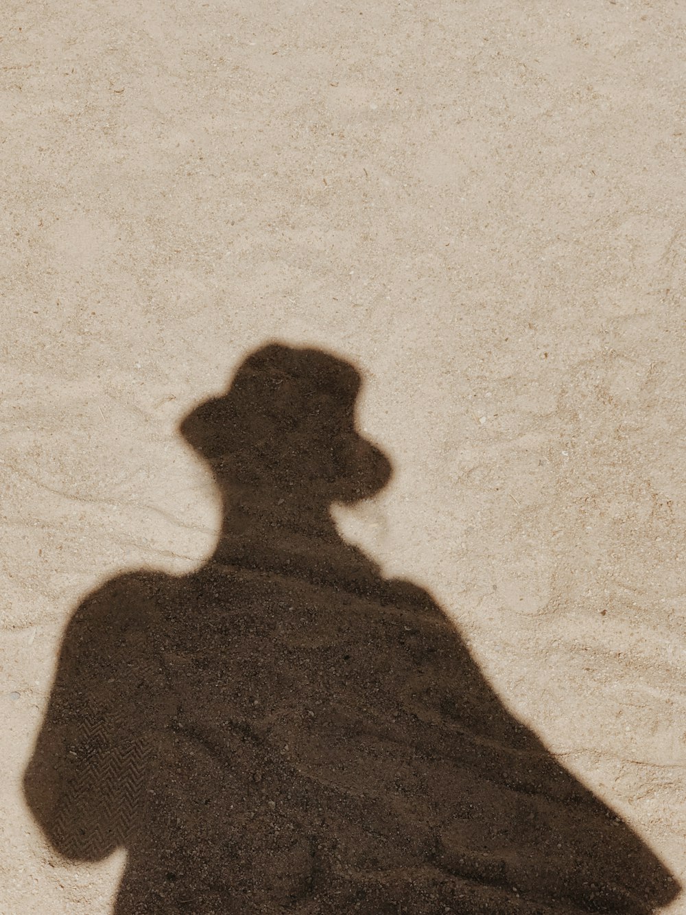 shadow of person on white sand