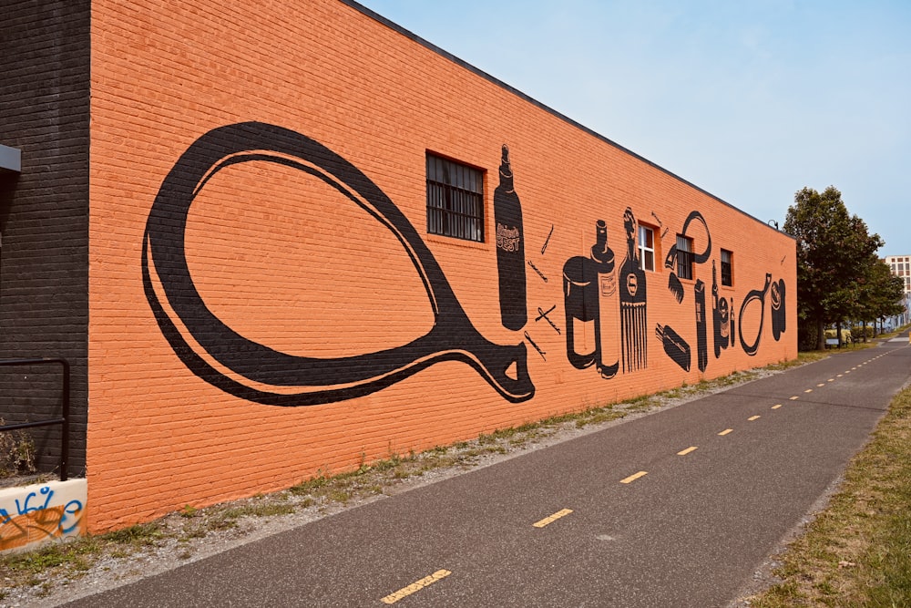 brown brick wall with graffiti