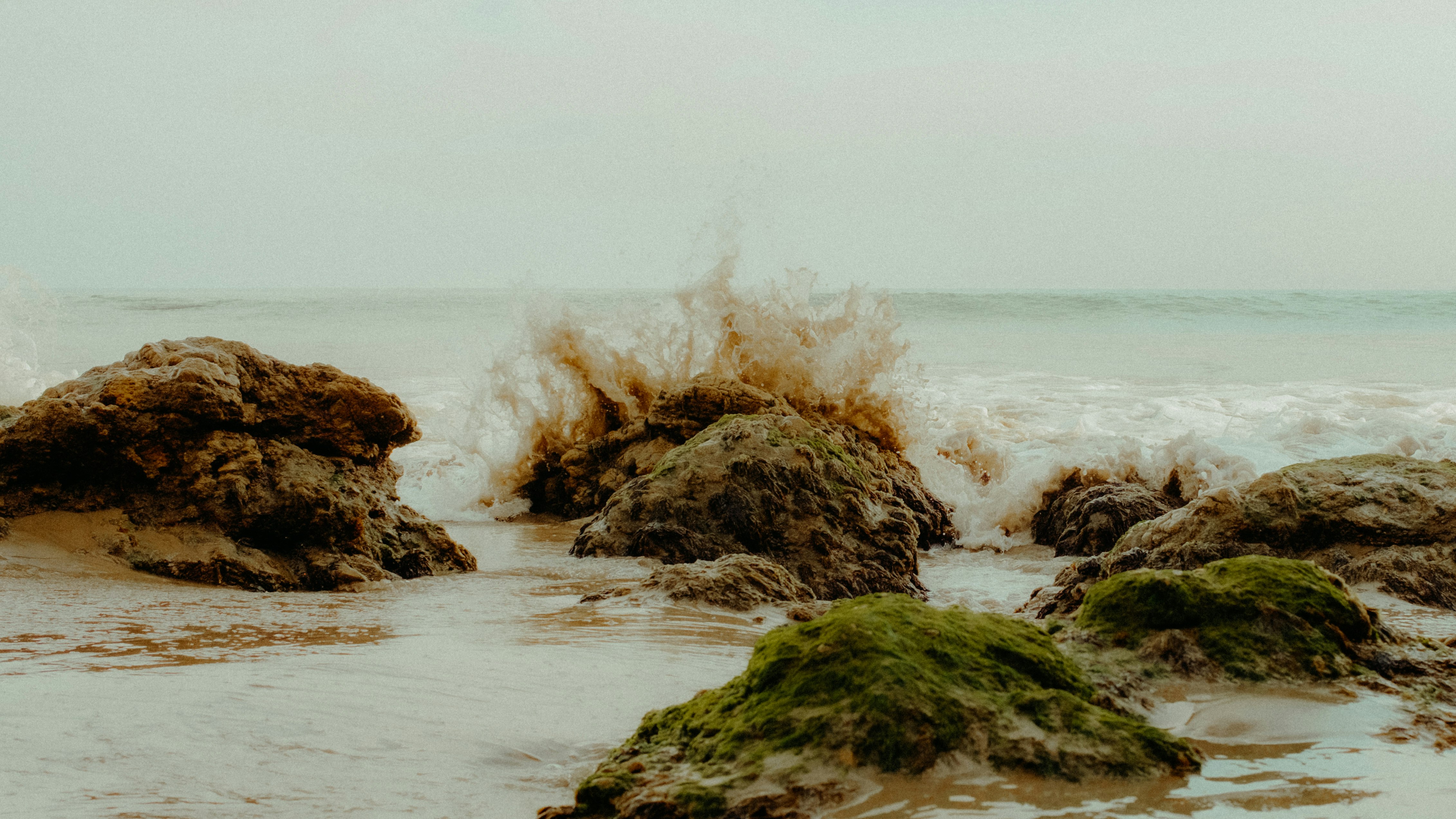 brown rock formation on sea water during daytime