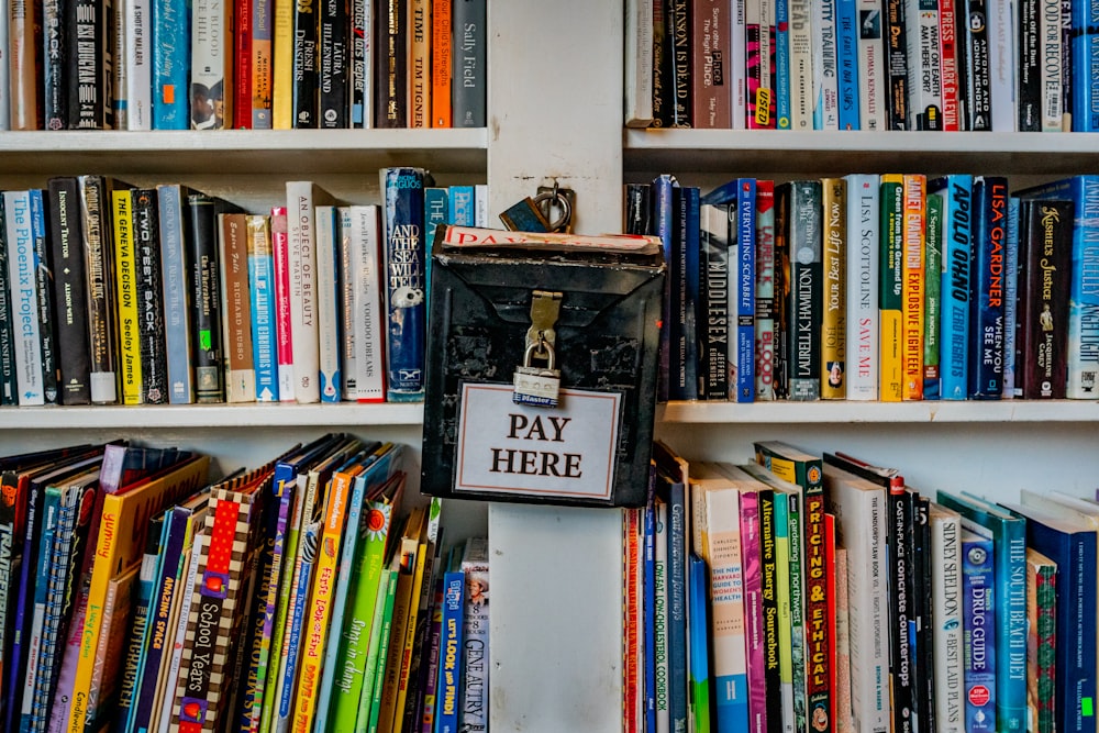 books on white wooden shelf