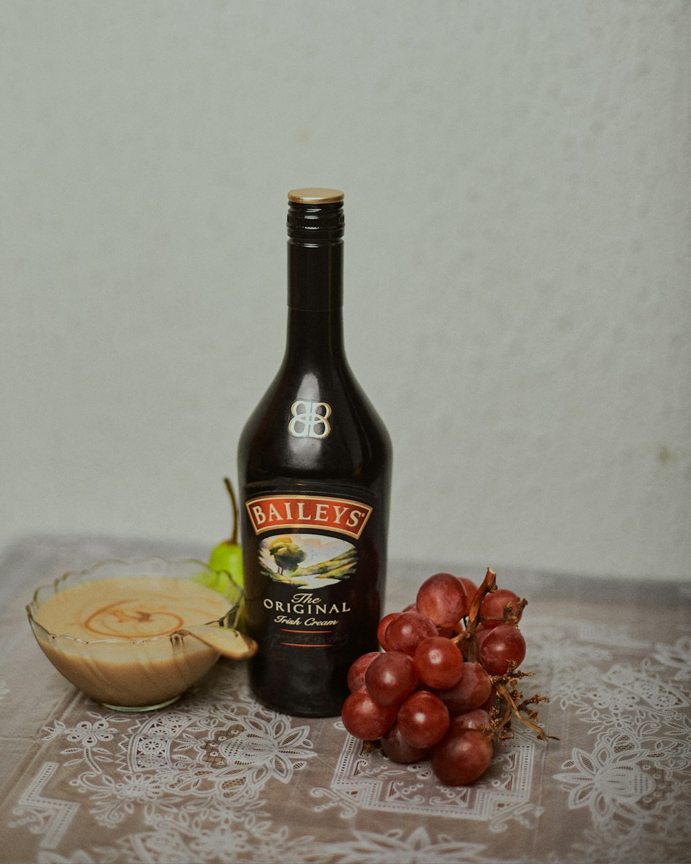 black glass bottle on brown wooden table