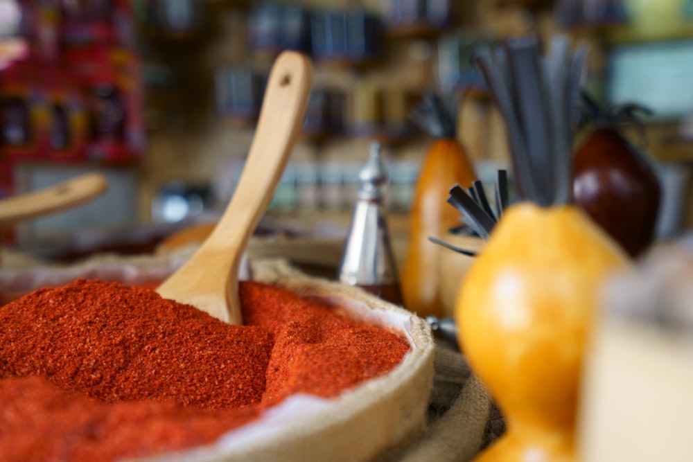 brown wooden ladle on white and red powder