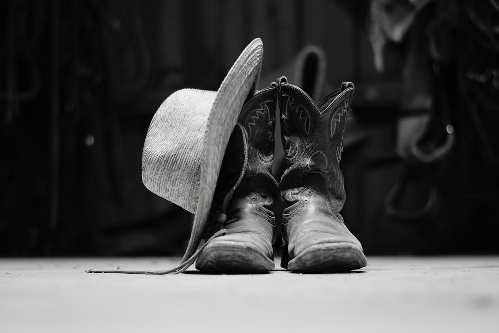 grayscale photo of cowboy boots