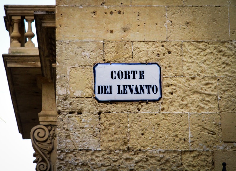 Narrow cobblestone street with aged stone buildings in Lecce