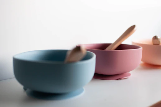 A cozy baby spoonful of homemade puree in a soft pastel bowl.