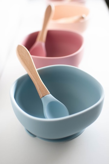 white ceramic bowl with silver spoon