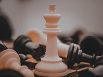 Minimalist chessboard with a focus on a white king piece representing leadership.