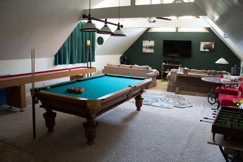 brown wooden billiard table on gray carpet