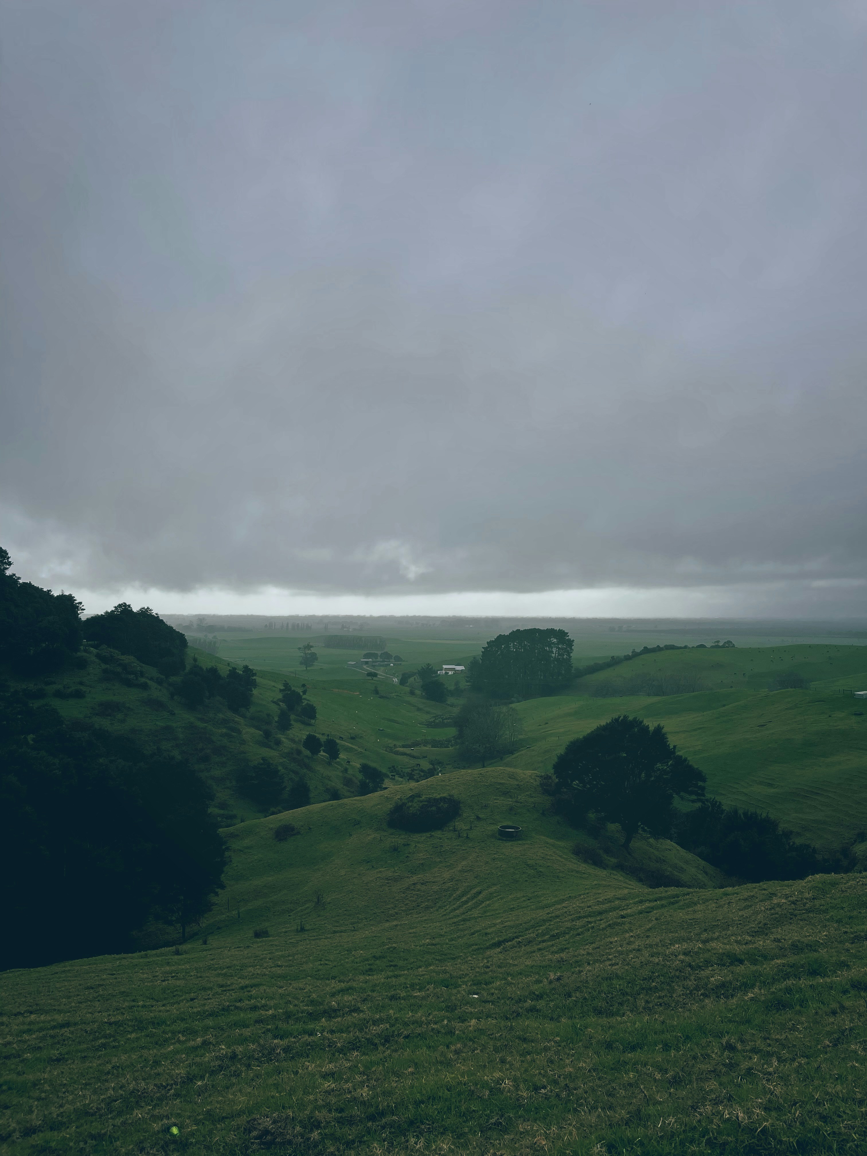 green grass field under cloudy sky during daytime