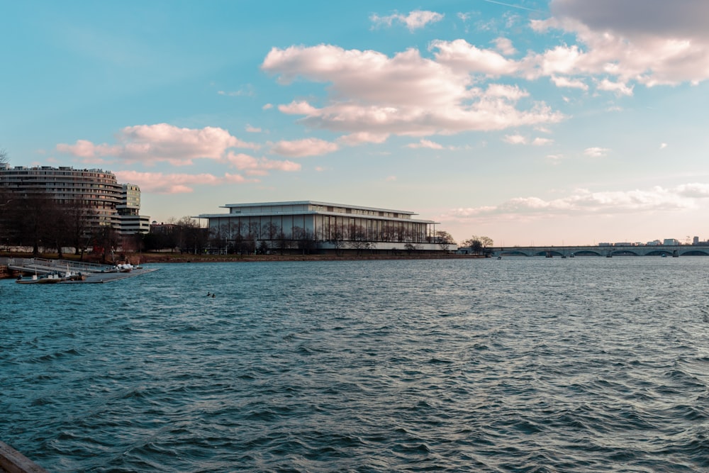 body of water near buildings under blue sky during daytime