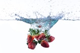 strawberries in blue glass bowl