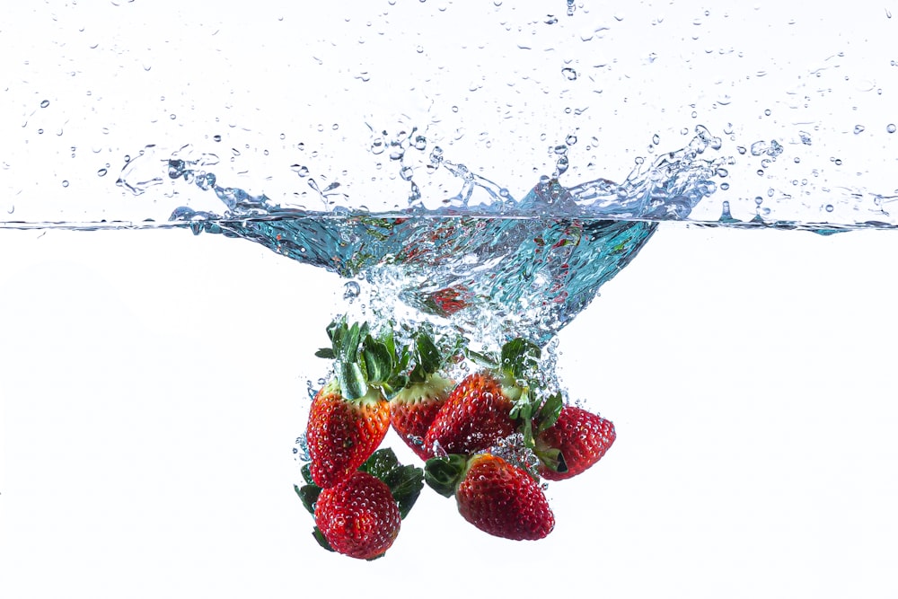 strawberries in blue glass bowl