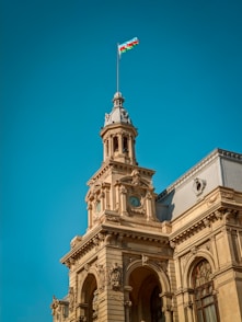 brown concrete building with flag of us a on top