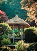 Custom-built wooden gazebo nestled in a backyard garden.