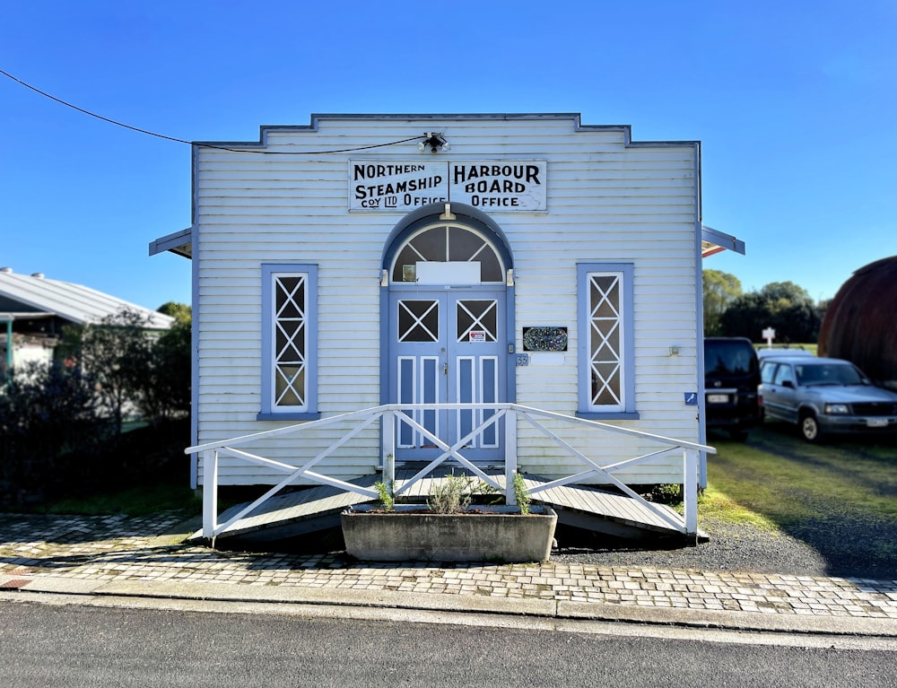 a small white building with a blue door