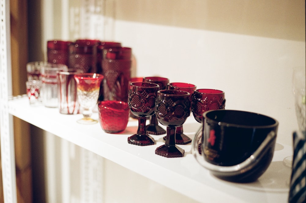 red glass candle holder on white table