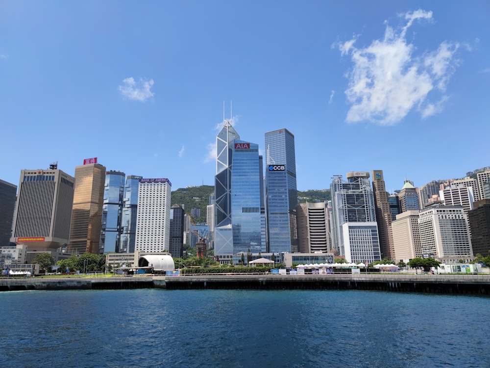 white and blue boat on water near city buildings during daytime