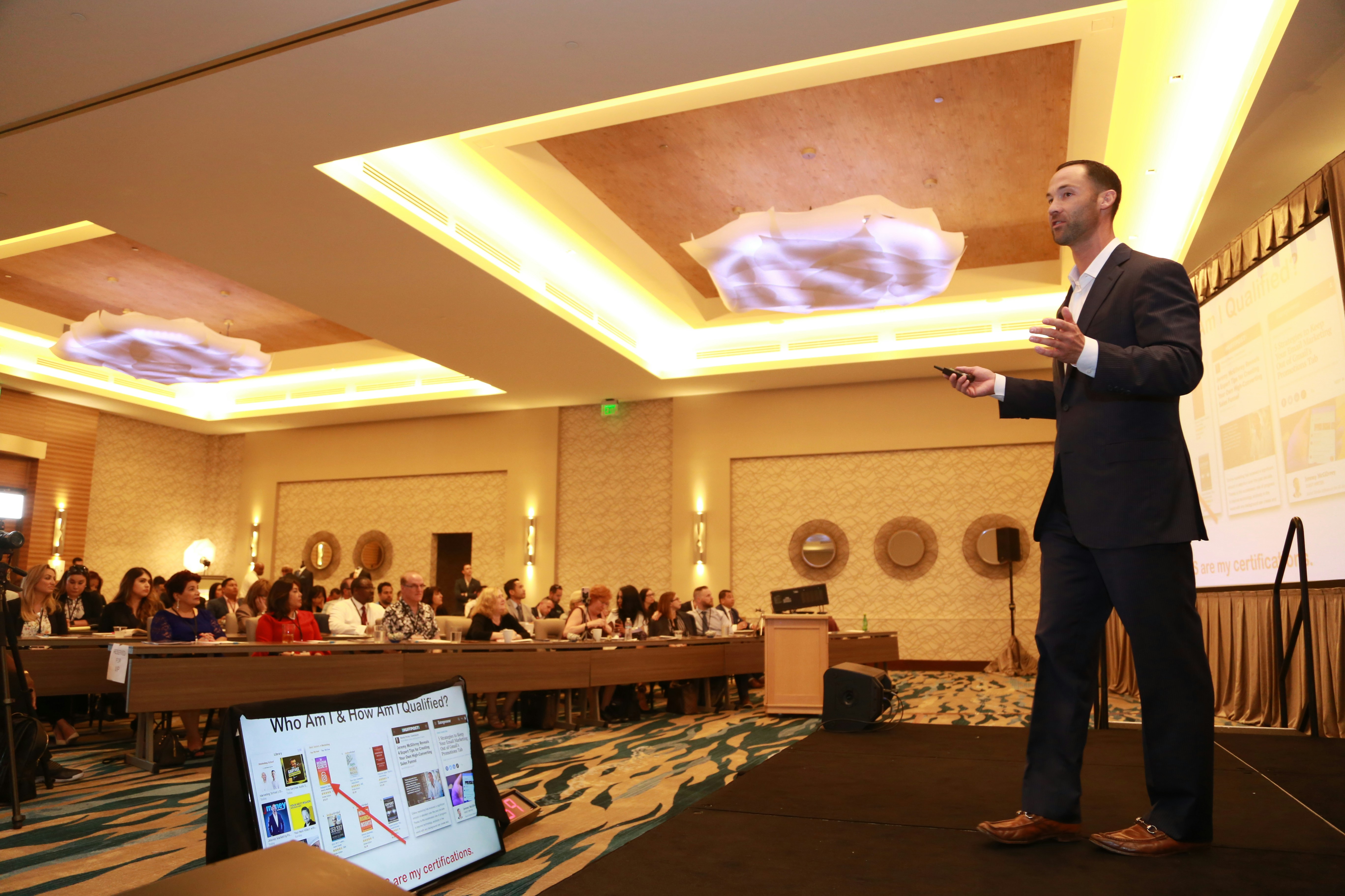 Corporate executive in business suit presenting at conference