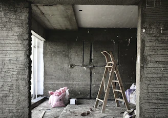 brown wooden ladder leaning on wall