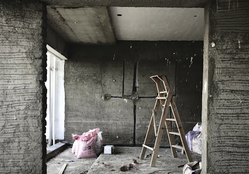 brown wooden ladder leaning on wall