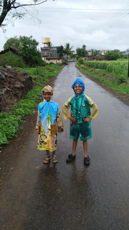 Rajeev Tirkey inaugurating a new water supply project, smiling alongside local children.