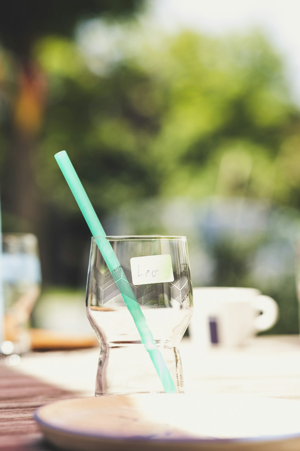 clear drinking glass with blue straw