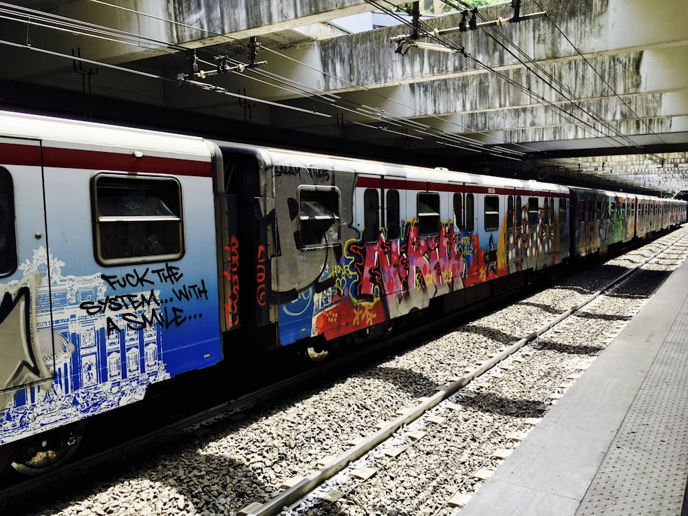 blue red and white train on train station