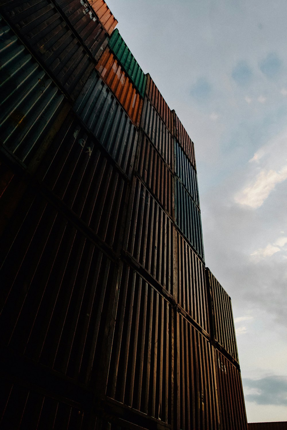 black concrete building under white clouds during daytime