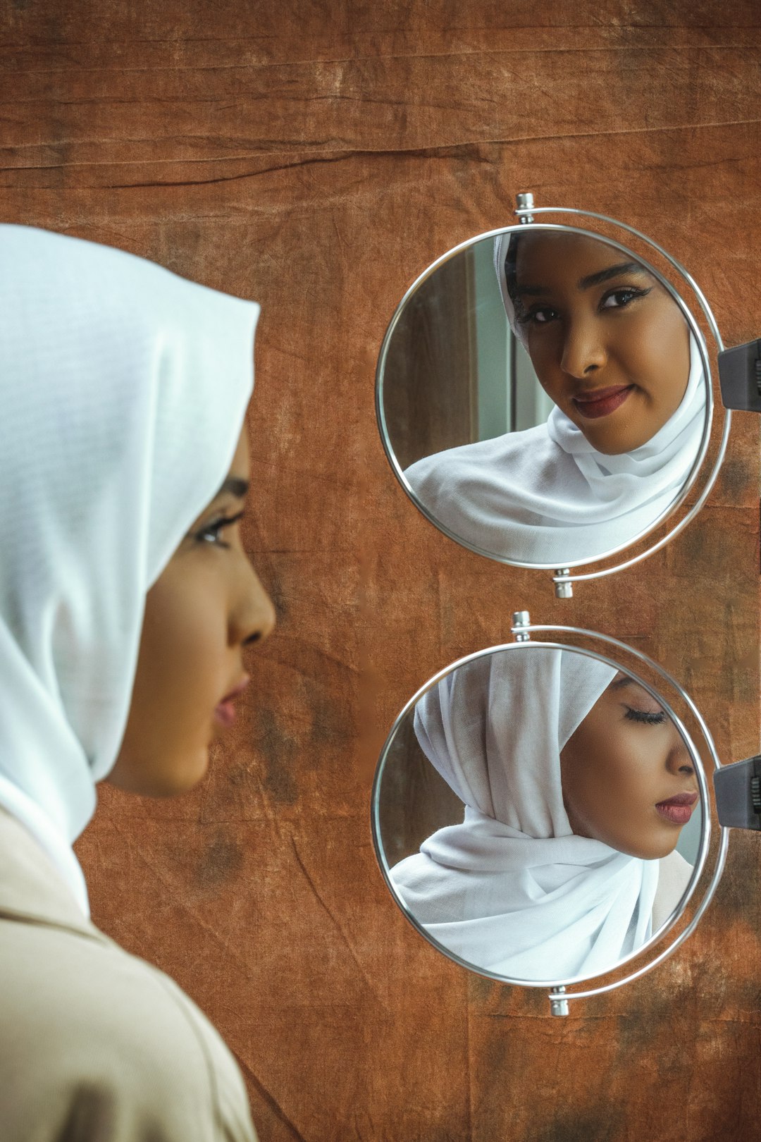 woman in white hijab taking selfie