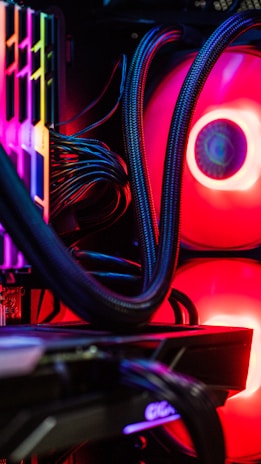 A technician carefully installing components inside a desktop computer tower.
