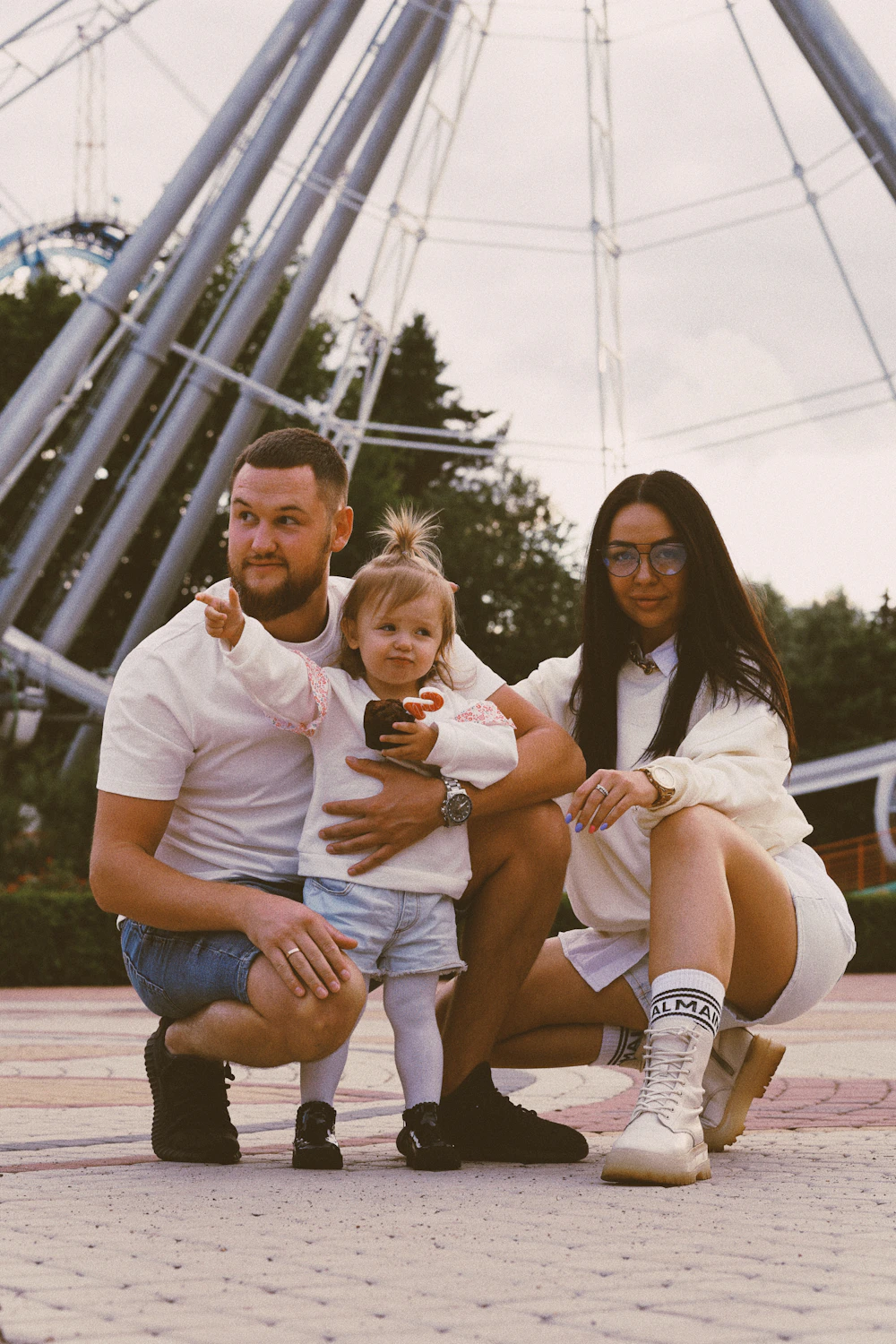 Family enjoying rides and attractions at a theme park