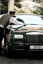 A professional detailing center with technicians polishing a vehicle.