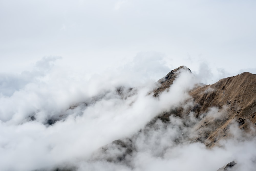 brown and white mountain under white clouds during daytime