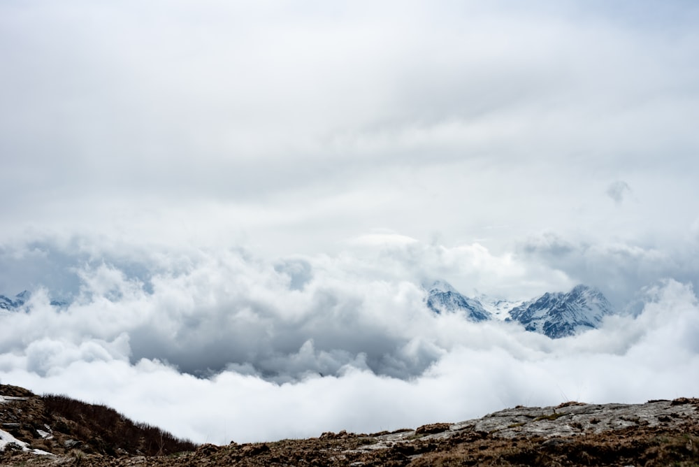 white clouds over brown mountain