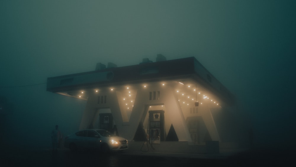 white car parked near white building during night time