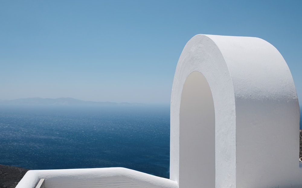 white concrete building near body of water during daytime