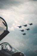 black jet plane in mid air during daytime