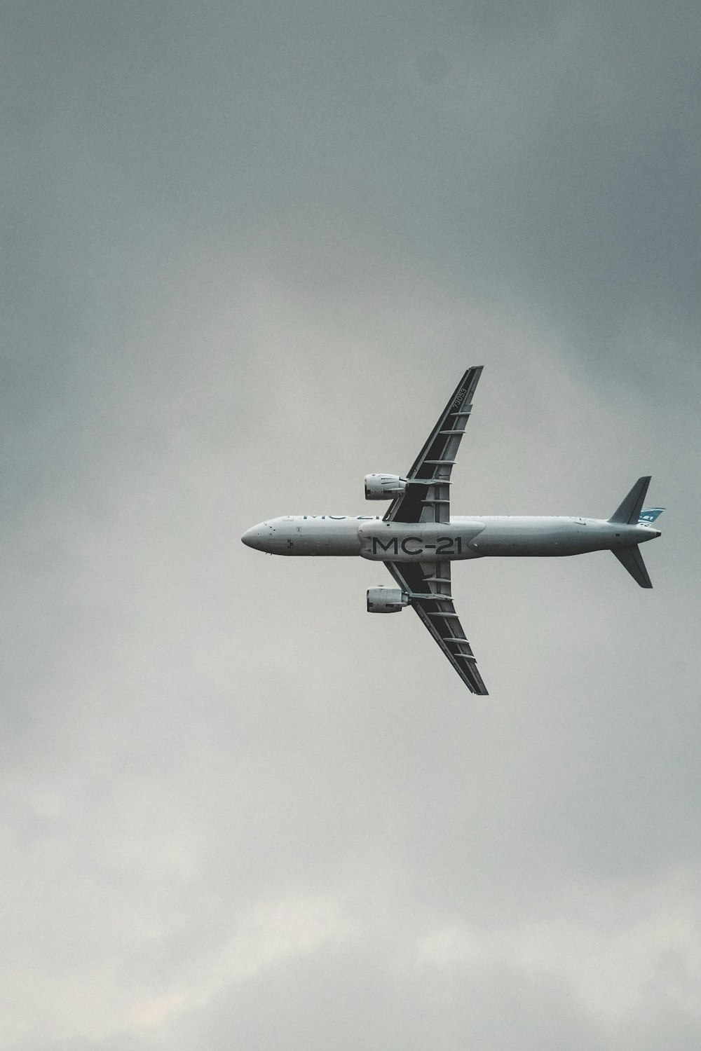 gray airplane under gray sky