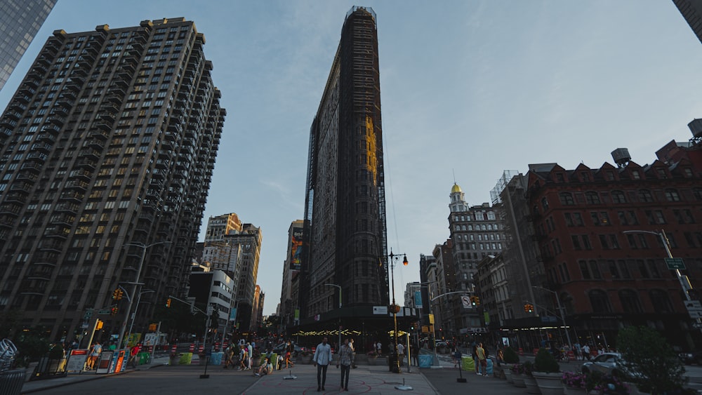 people walking on street near high rise buildings during daytime