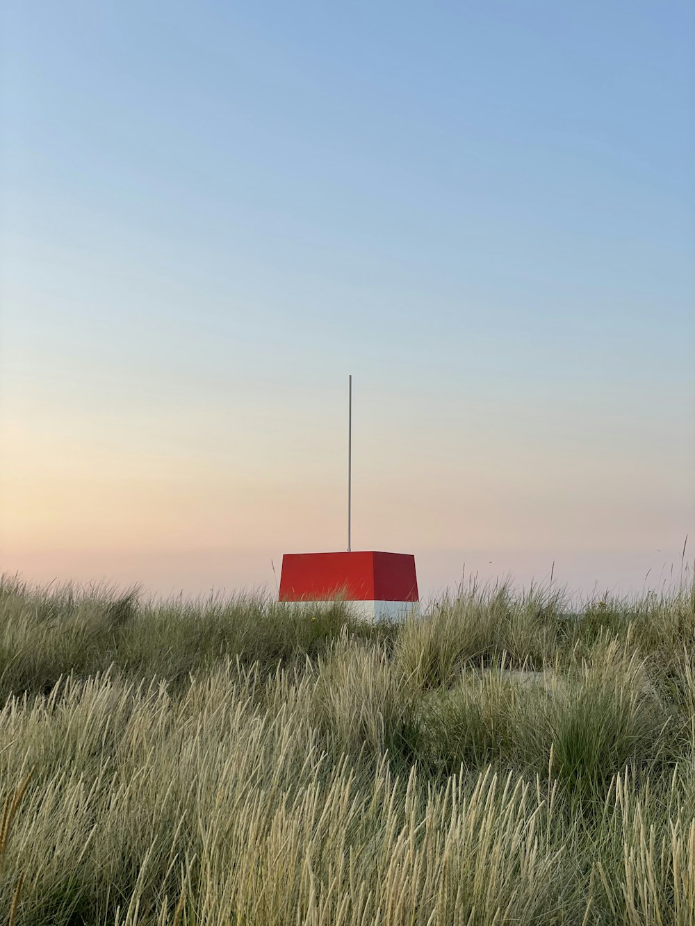 red signage on green grass field during daytime