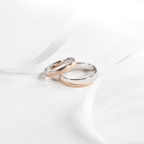 Elegant wedding bands in 10k and 14k gold displayed on a velvet cushion
