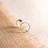 silver ring on brown textile