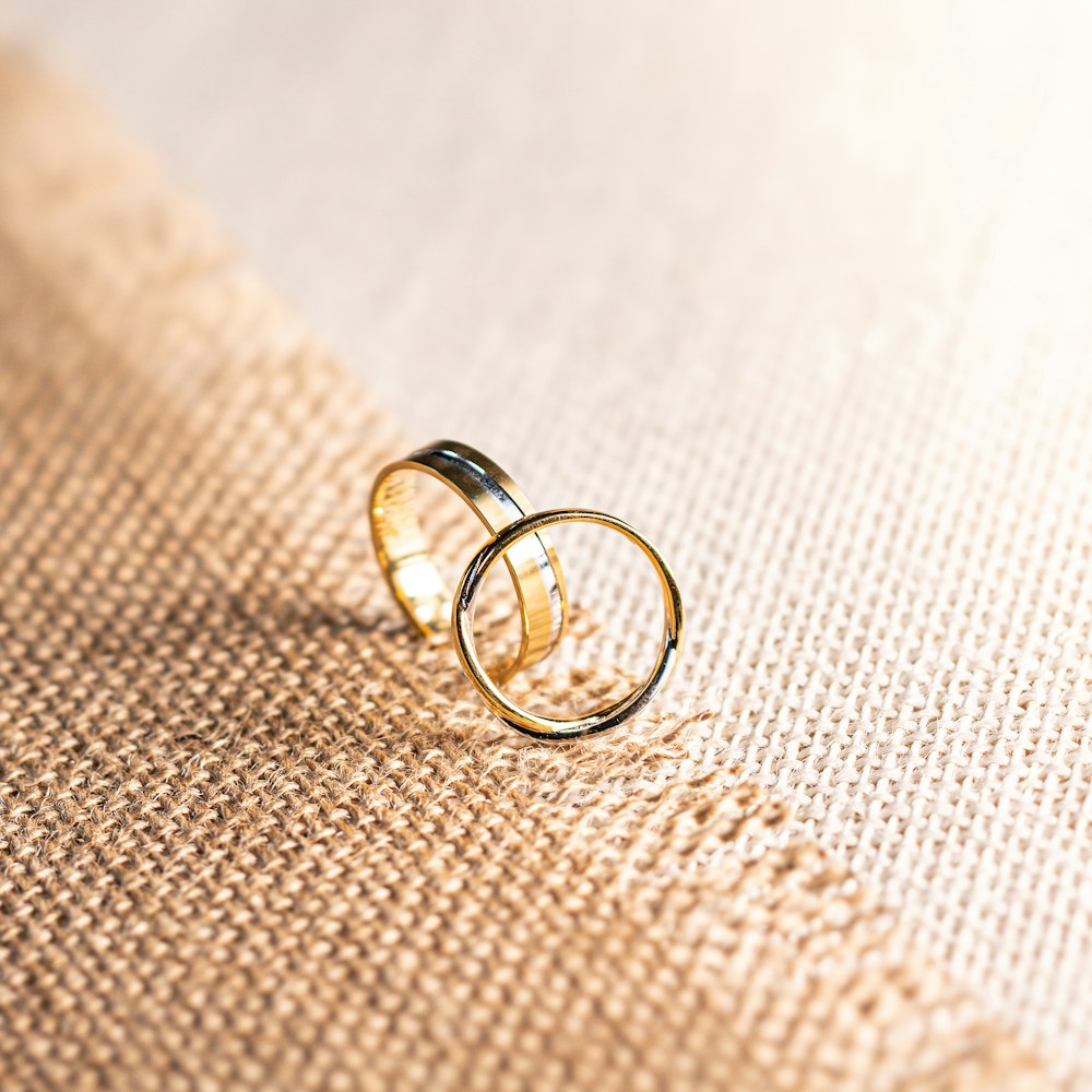 silver ring on brown textile