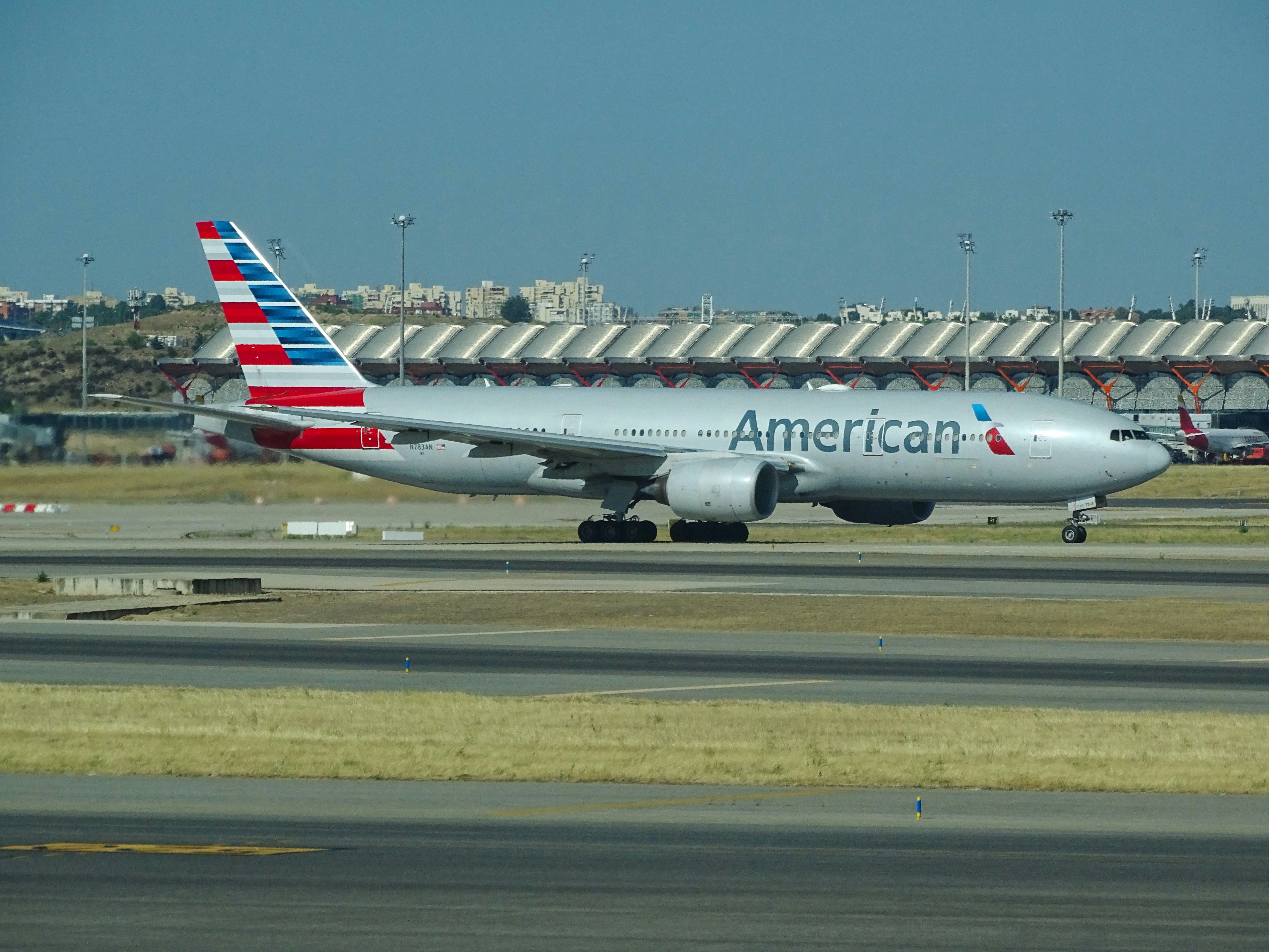 white and red passenger plane on airport during daytime, American Airlines B777-200ER</p><p>