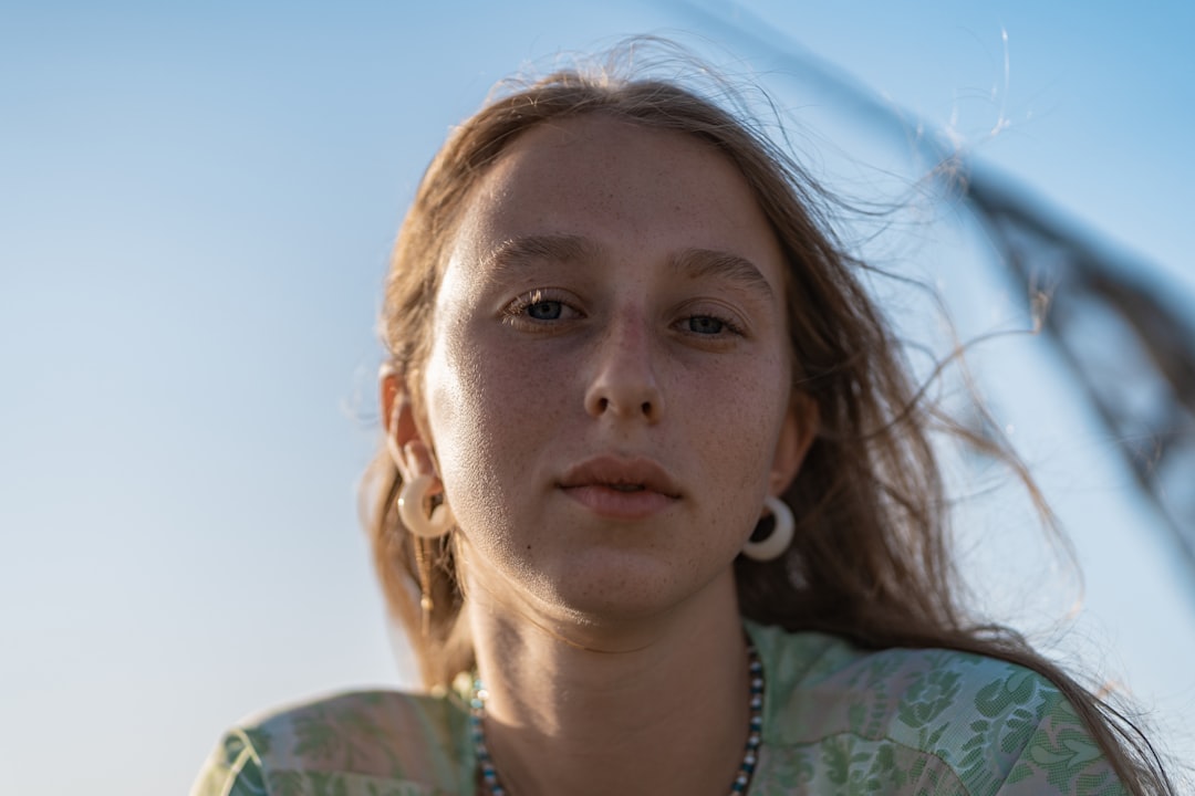 woman in green and white floral shirt