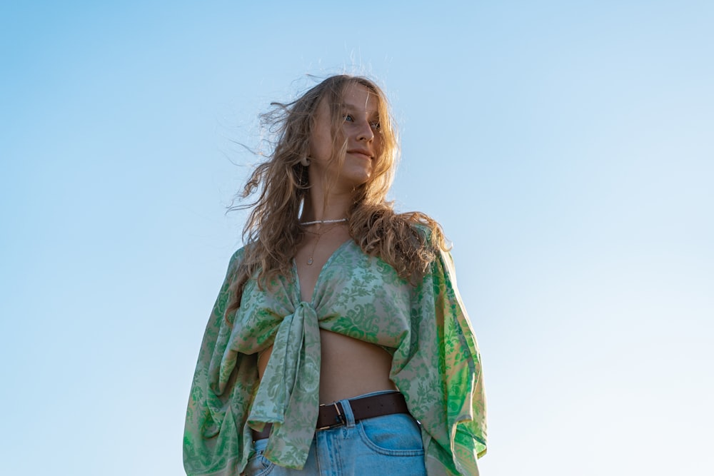 woman in green and brown floral cardigan and blue denim jeans