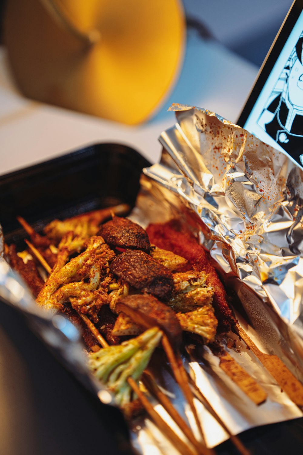 fried meat on black plastic container