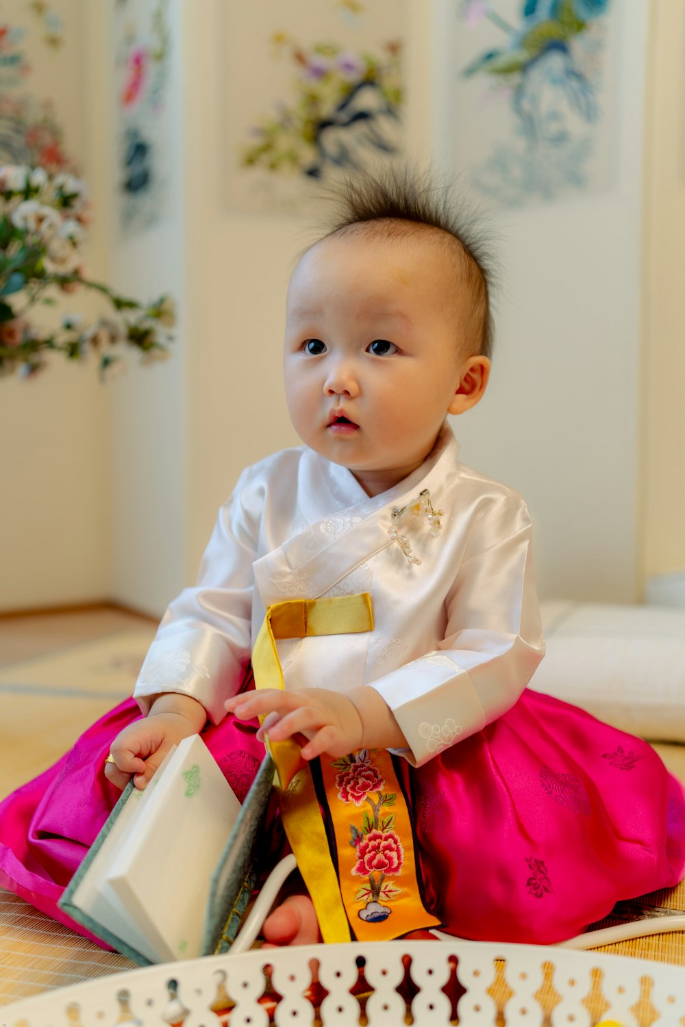 baby in white dress shirt sitting on bed